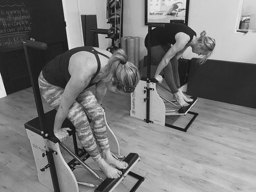 Instructor assisting a client with an exercise